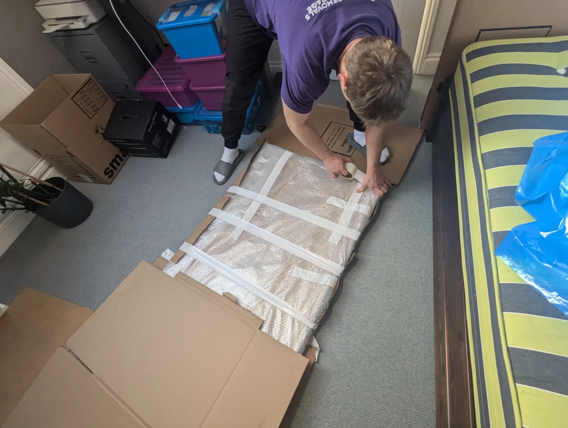 Antique painting being packed securely by RAD removals crew